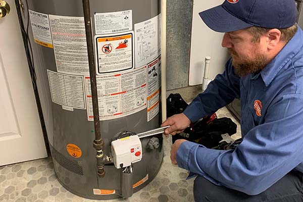Technician performing Water Heater Maintenance